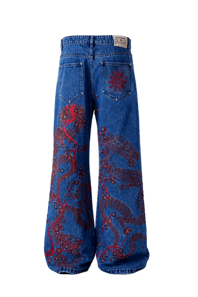 Blue denim jeans with red dragon embroidery and rhinestone embellishments, shown from the back on a white background.