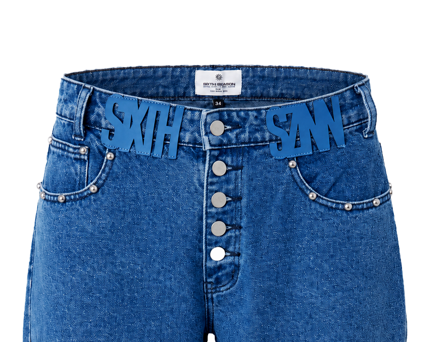 Close-up of a pair of blue denim shorts with a button-front fly, side pockets, and large blue 'SIXTH SZNN' letter patches across the waistband.